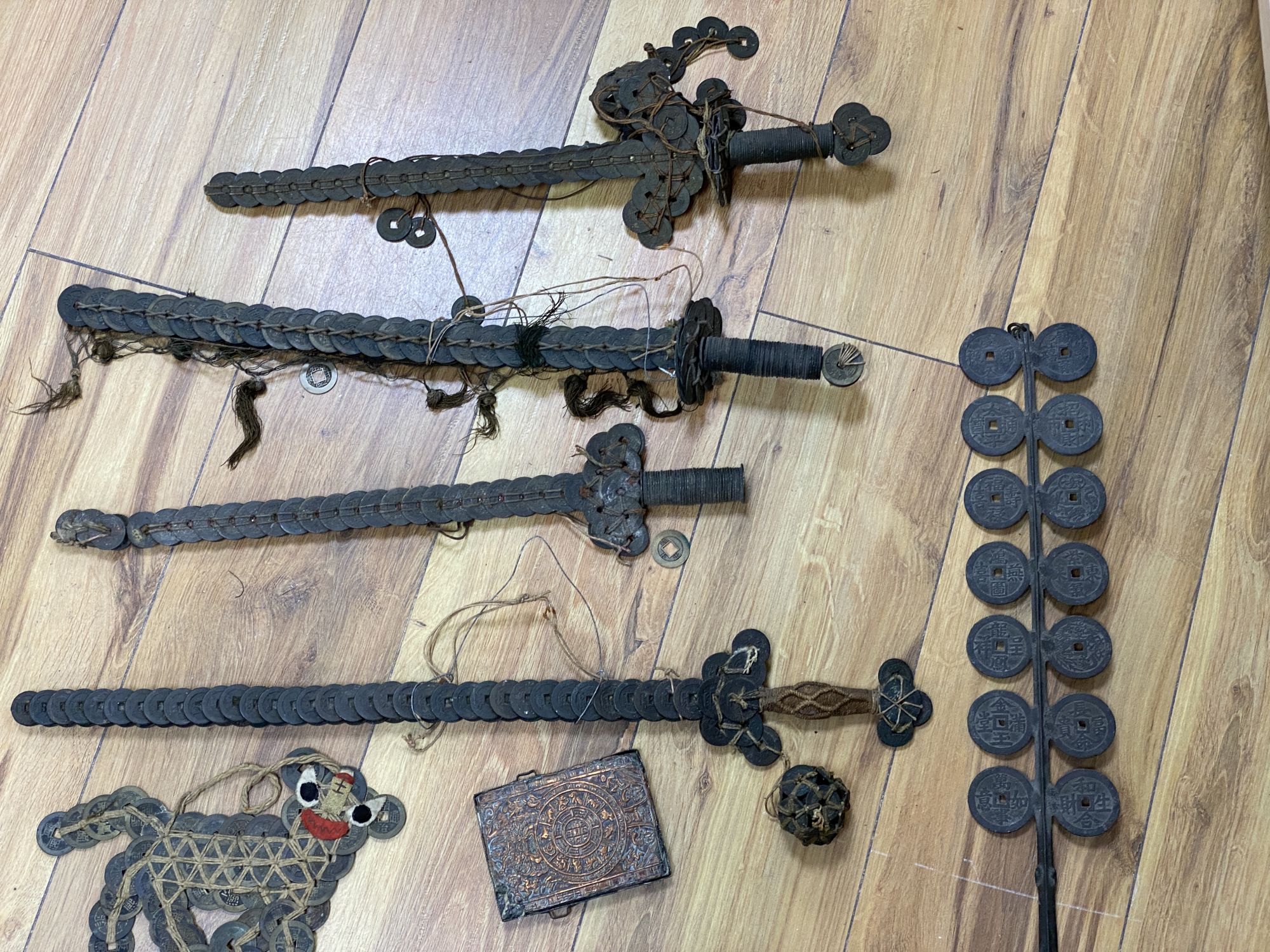 A group of Chinese coin swords and talismans,